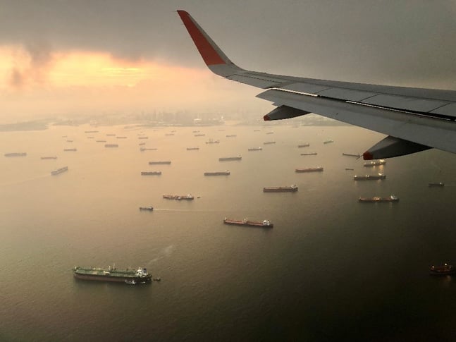 A plane flying over a body of water

Description automatically generated